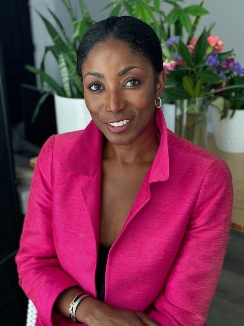 woman in pink suit smiling