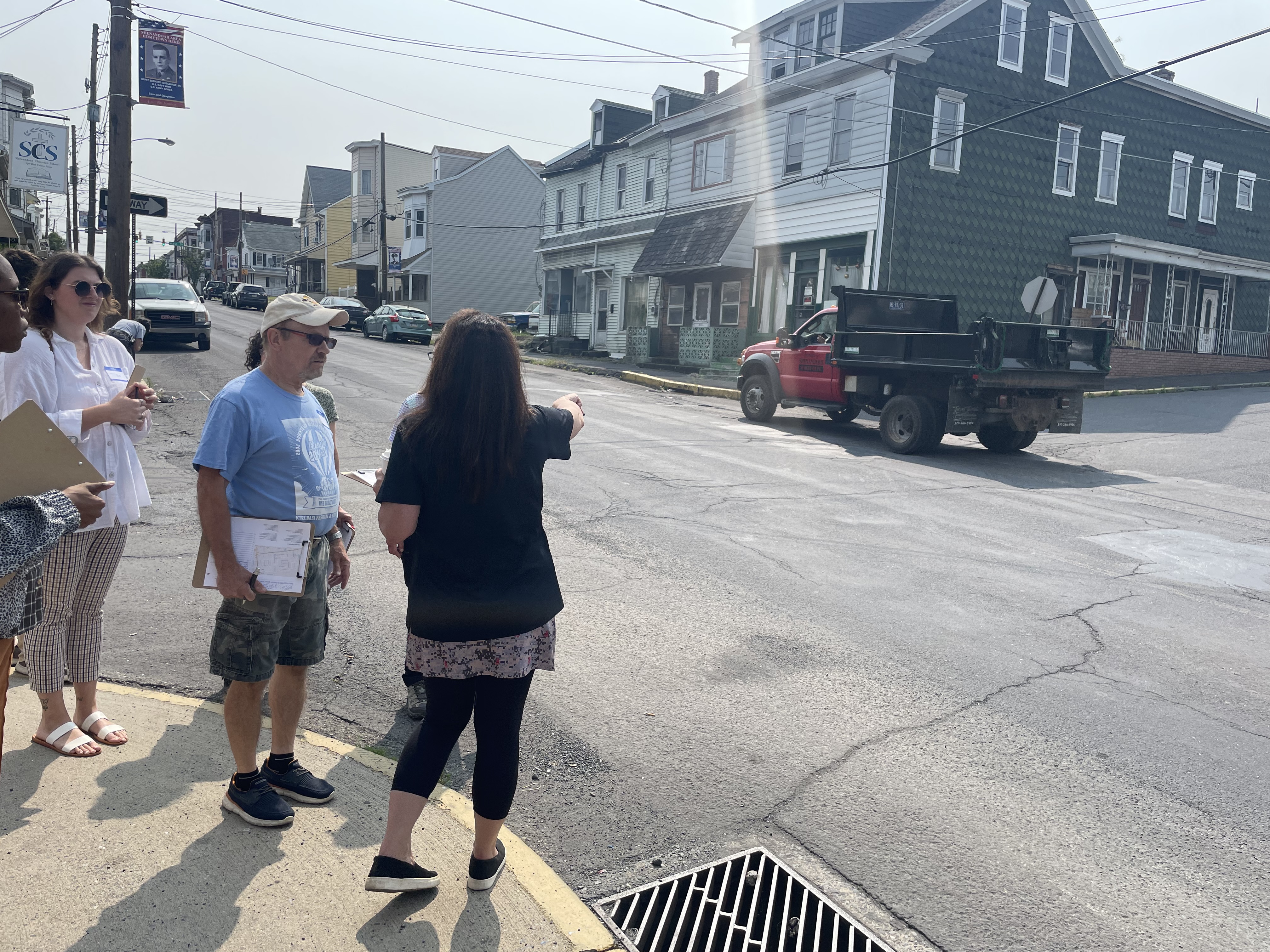 People standing on curb at intersection