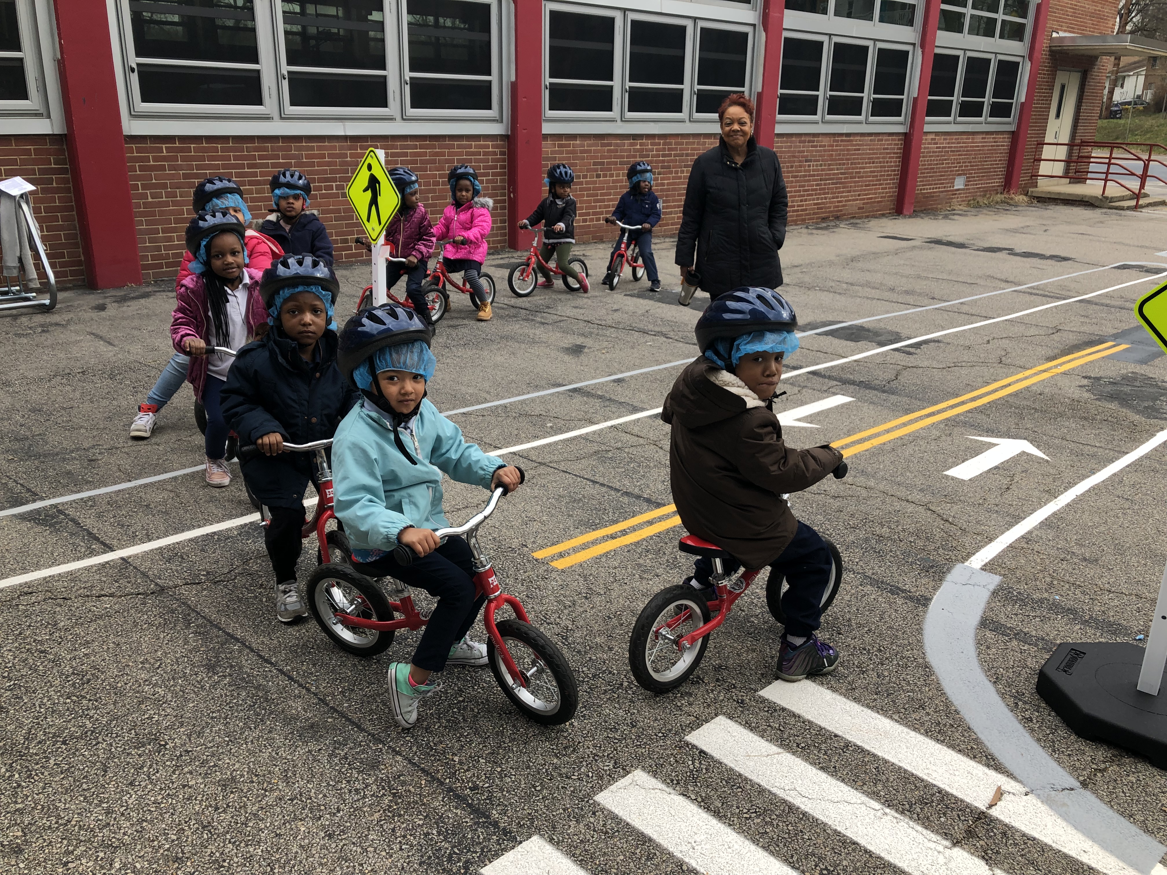 children riding bikes in a traffic garden
