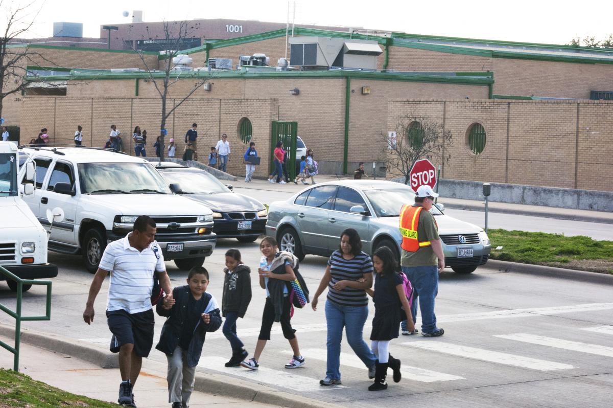 Kids and parents walking from school in Dallas, TX