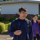 three individuals walking in crosswalk