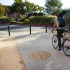 man riding bike down street